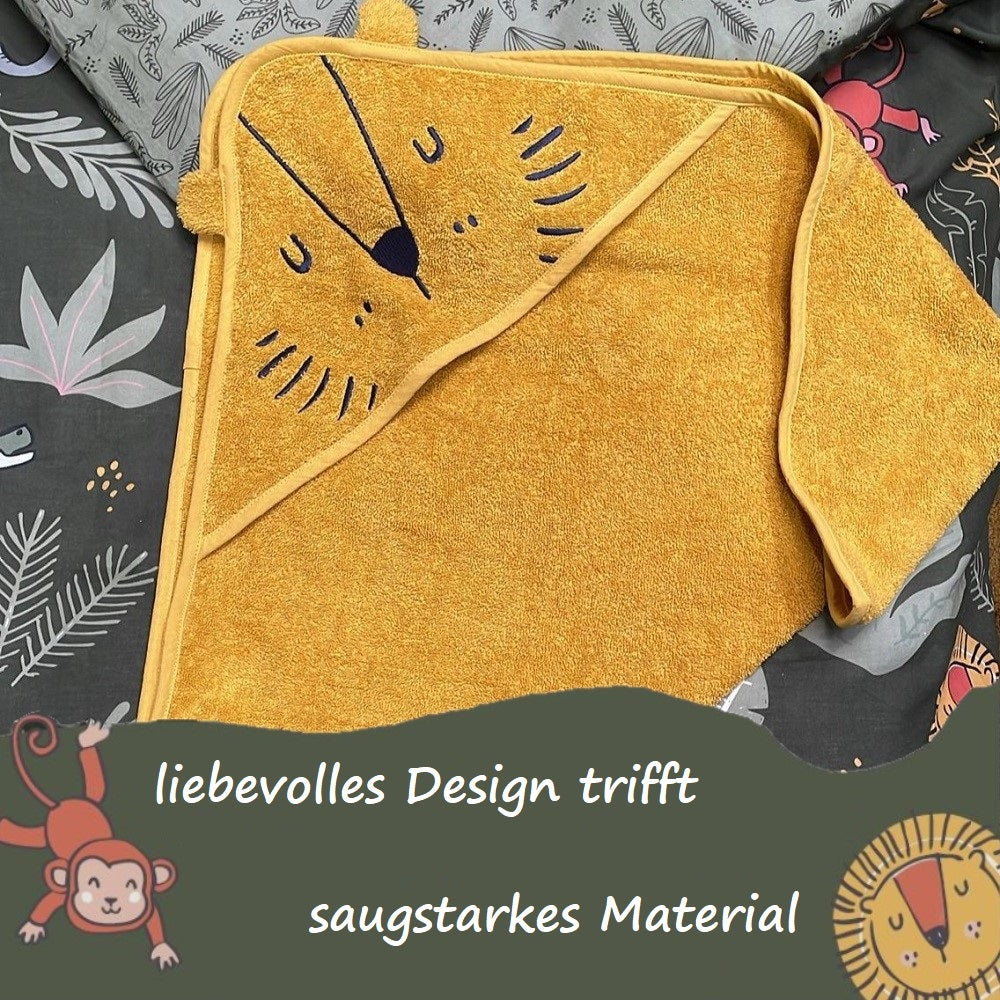 Löwenhandtuch für Kinder gefaltet auf passendem Bettbezug