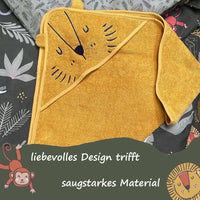 Löwenhandtuch für Kinder gefaltet auf passendem Bettbezug