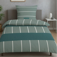 Grüne Mexx Bettwäsche auf Bett gezogen in dezent eingerichteten Raum